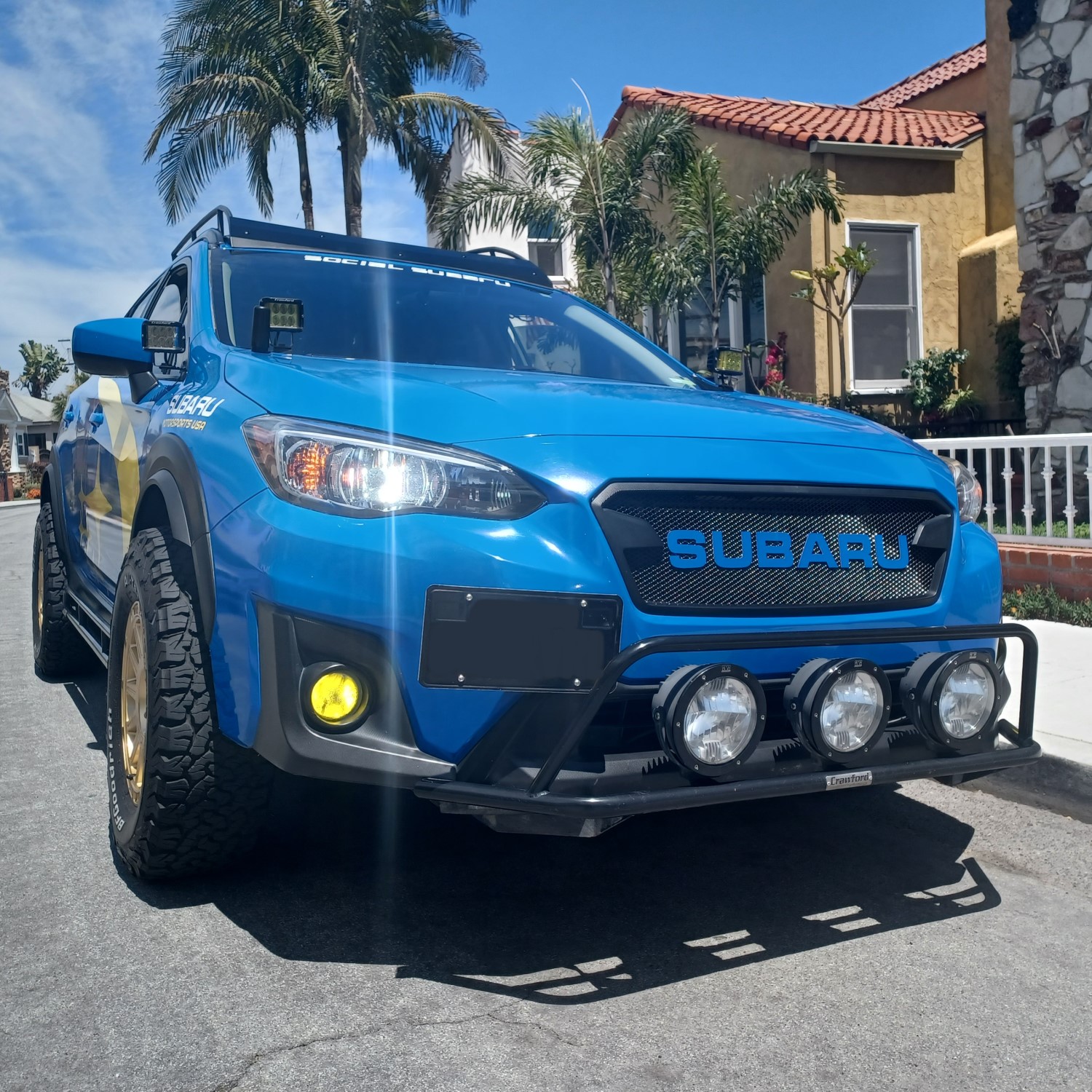 Personalized Style: Blue Wrapped Subaru Crosstrek with Color Matched Letters on Custom Grille