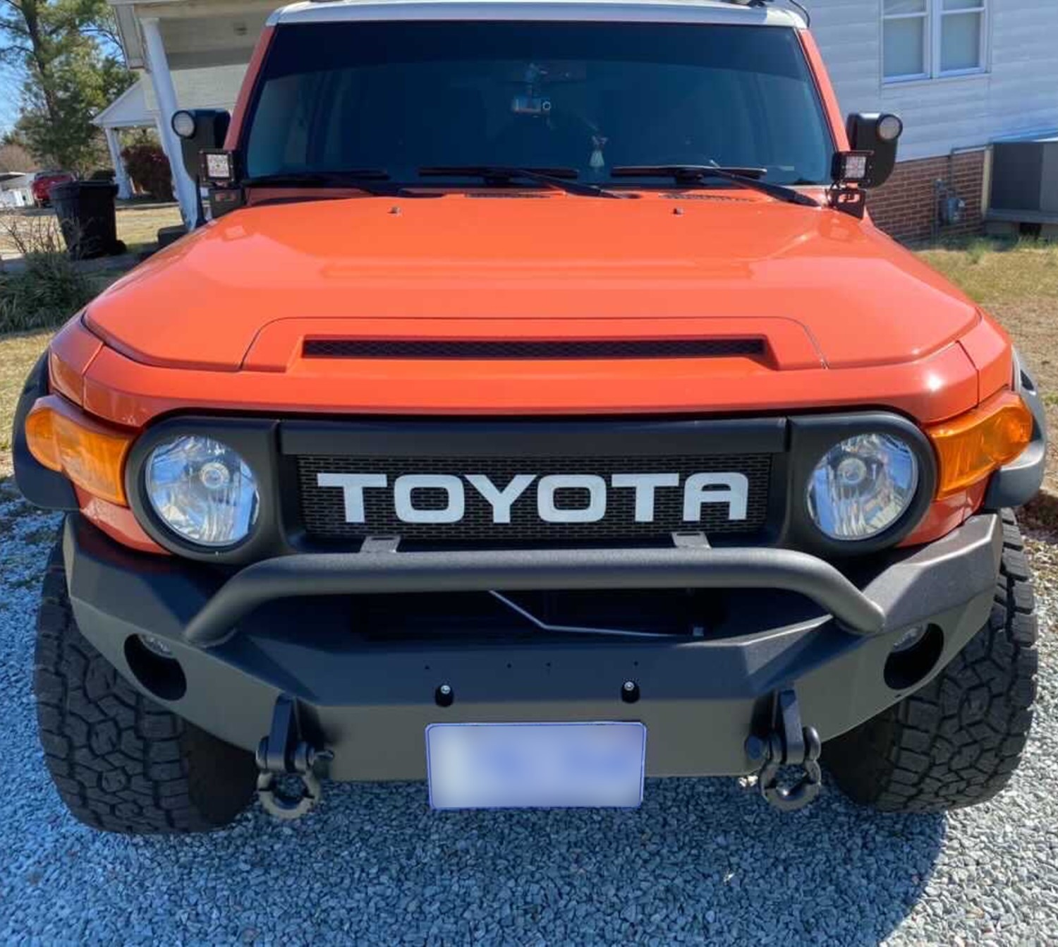 Magma Orange FJ Cruiser with Custom White Letter Grille: A Striking Sight