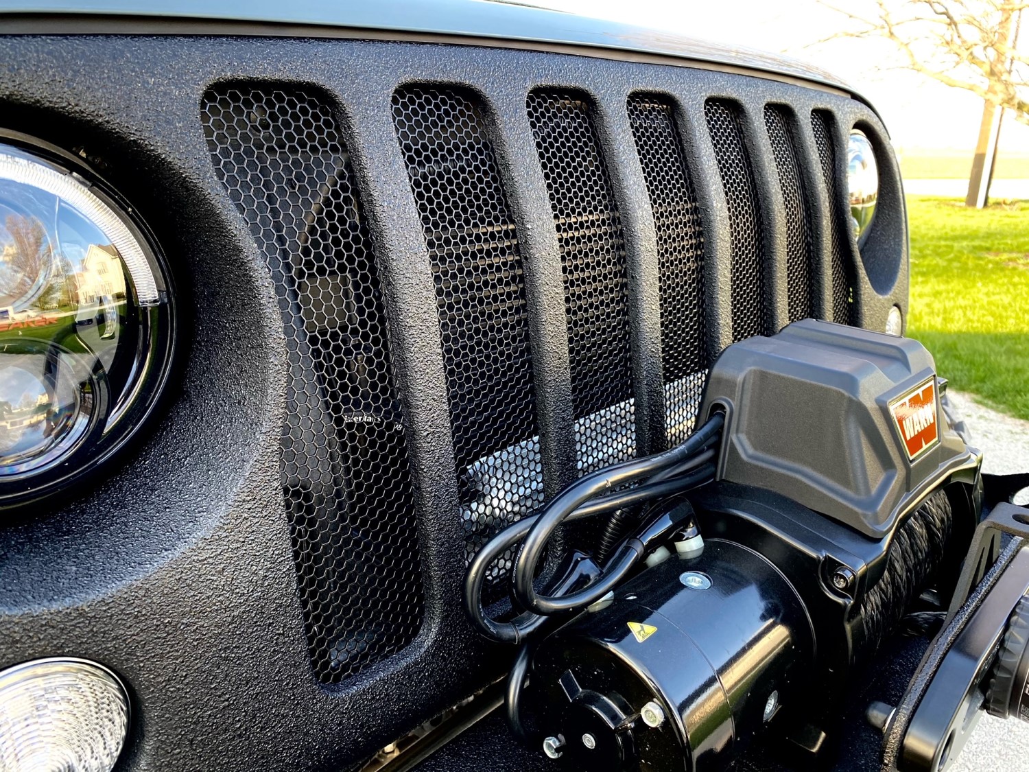 Elevate Your Jeep Wrangler's Look with a Custom Black Hexagon Mesh Grille Upgrade