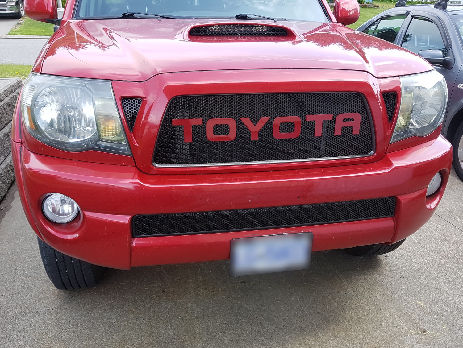 Radiant Red Custom Grille: A Bold Addition to Your Tacoma