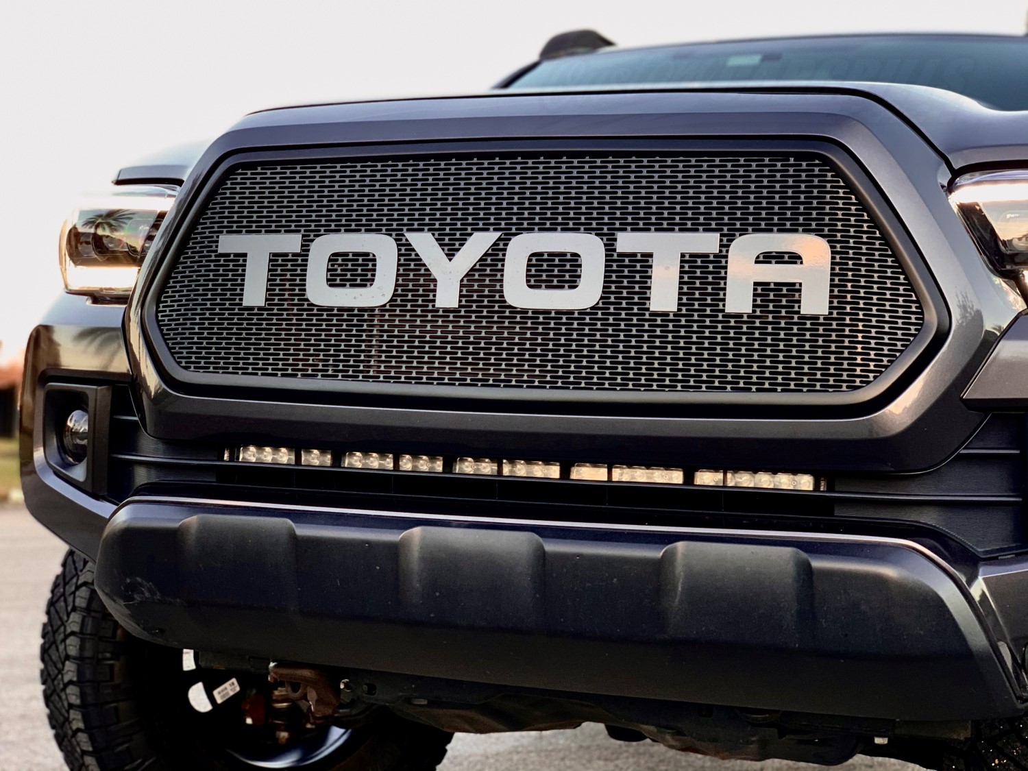 2016-17 Toyota Tacoma Customization: Custom Slotted Grille and Magnetic Gray Metallic Letters for a Unique Look