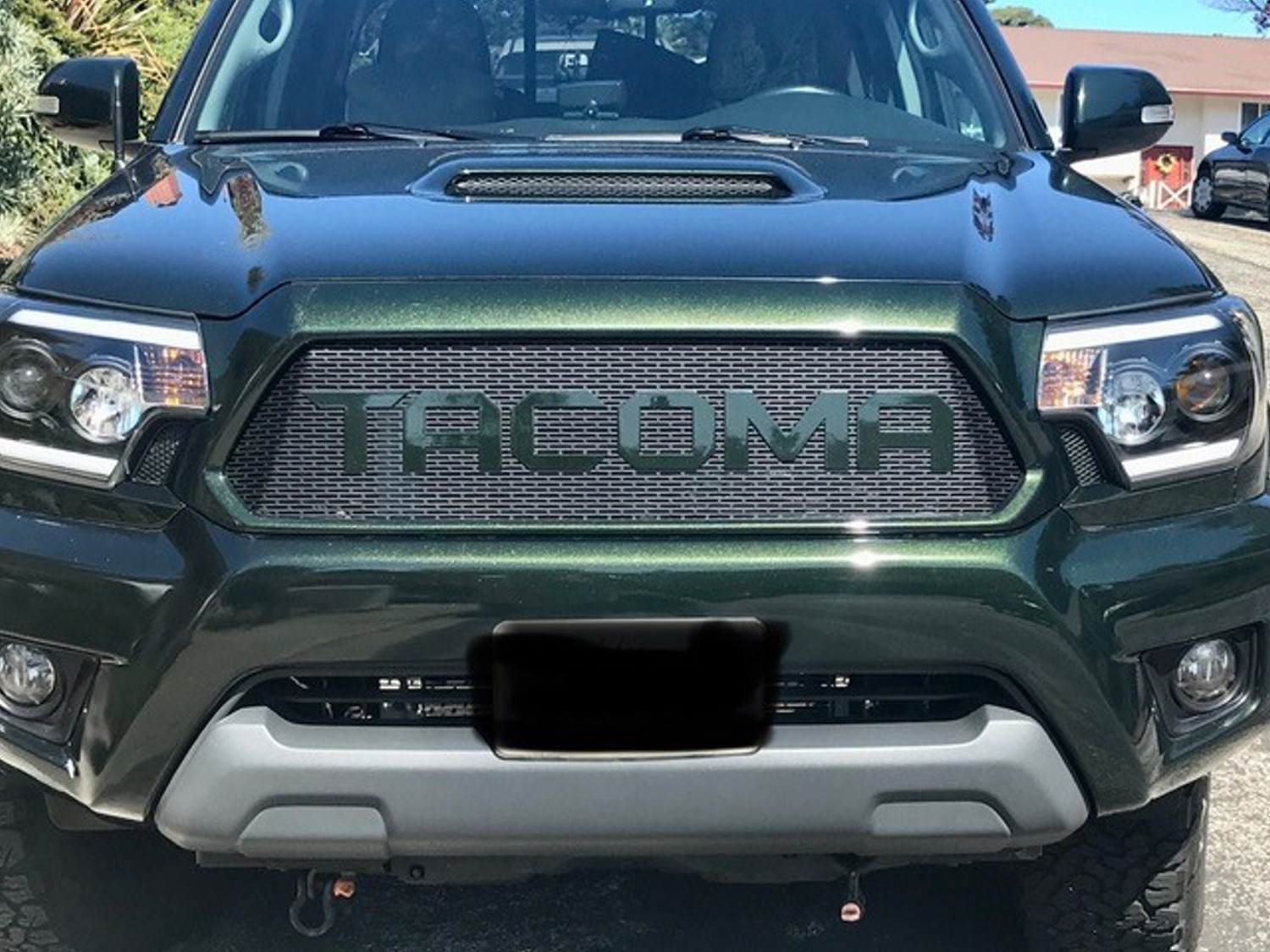 Enhancing the Unique Look of a Spruce Mica Toyota Tacoma with a Custom Mesh Grille